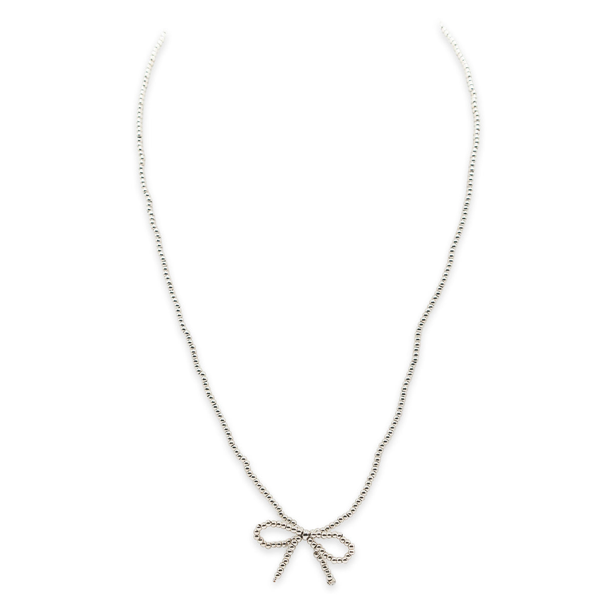 gold bow-shaped necklace on a white background