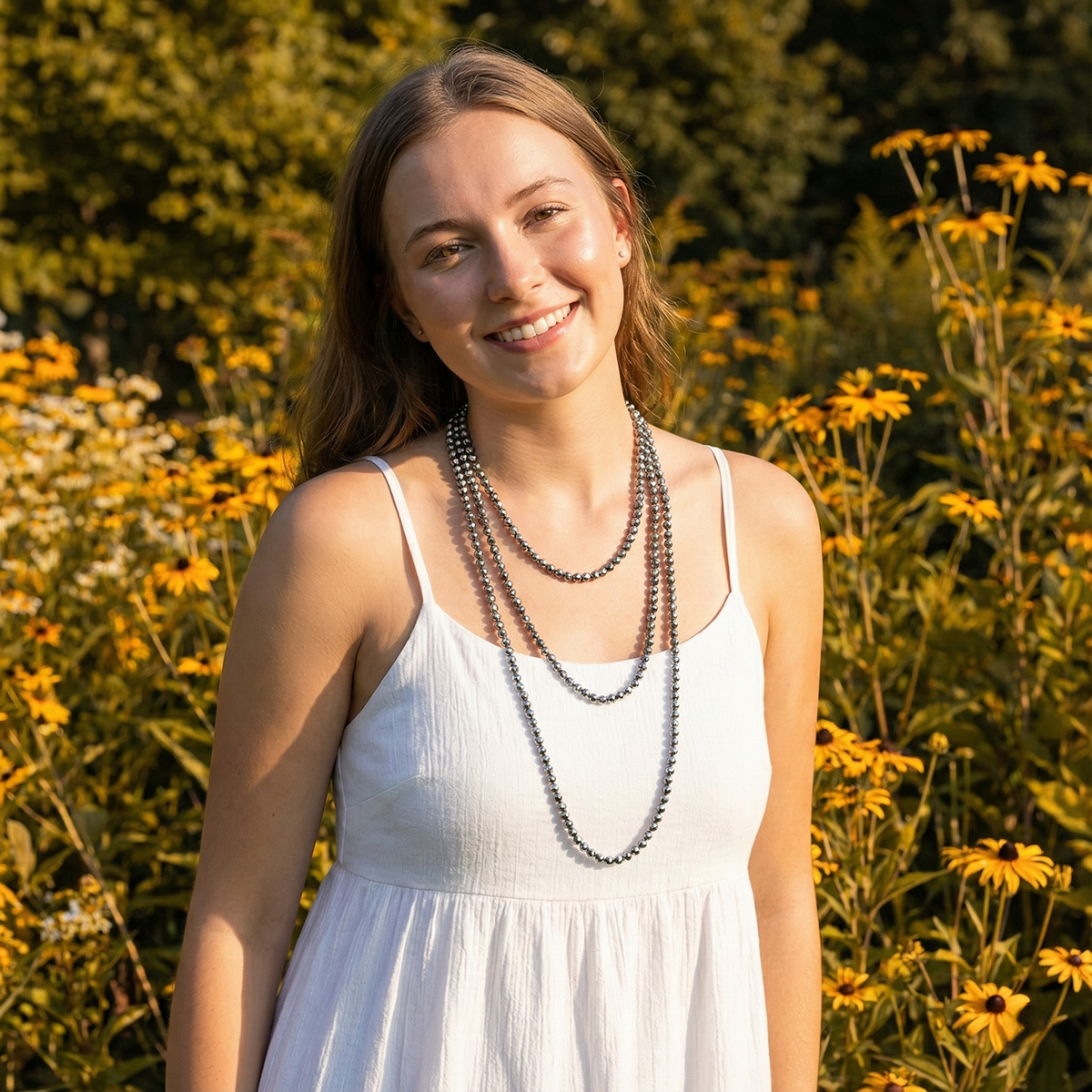 Woman in a white dress standing among yellow flowers