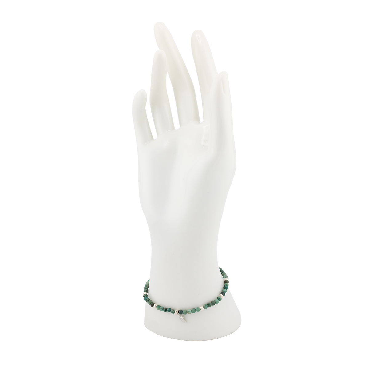 Green beaded bracelet on a white mannequin hand against a white background