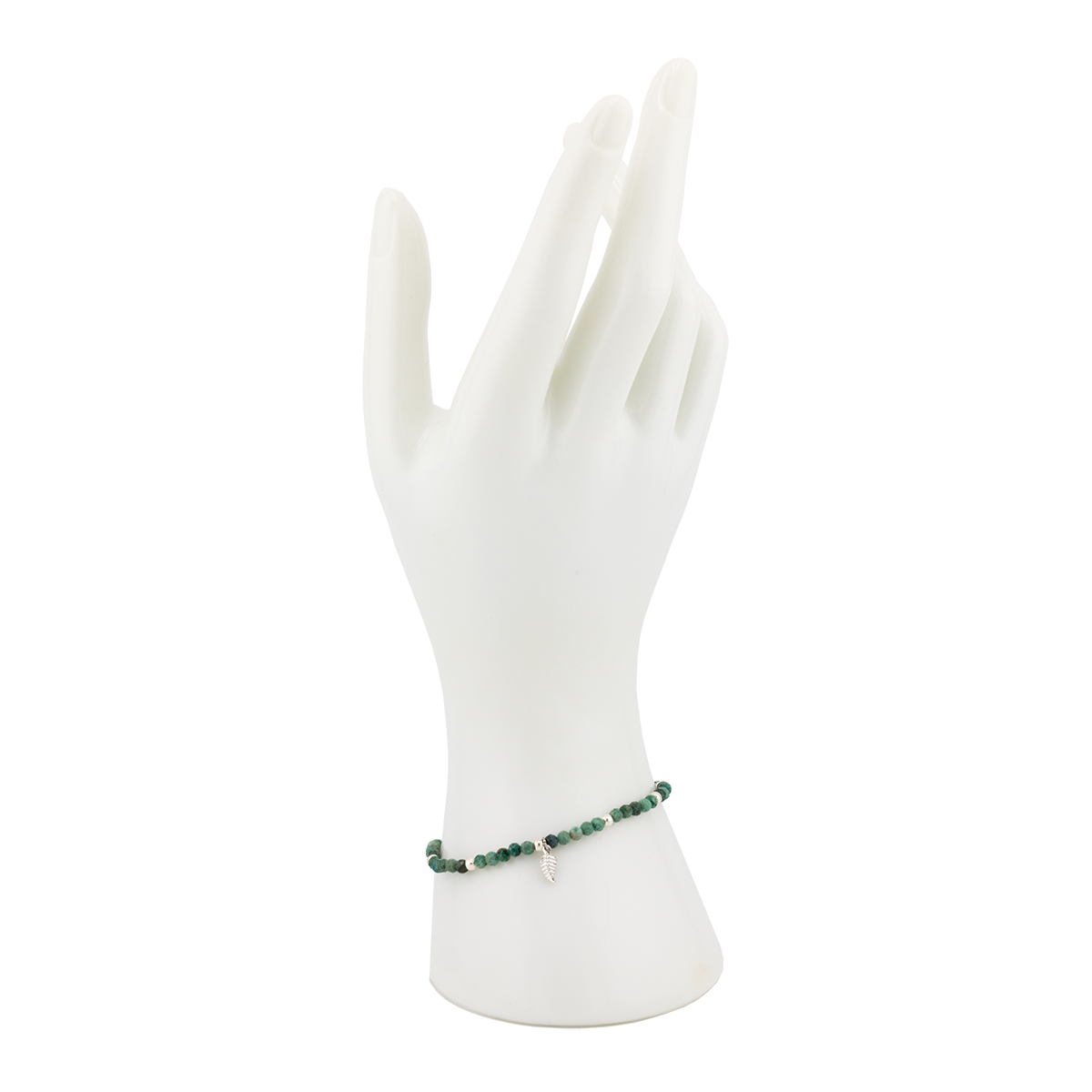 Green beaded bracelet on a white mannequin hand against a white background