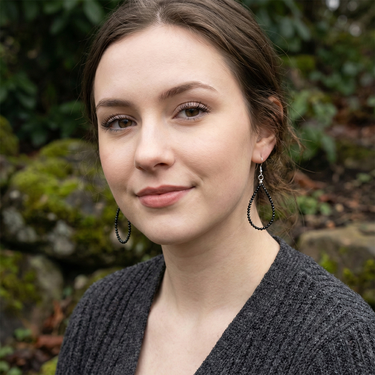 Woman wearing earrings with a natural background