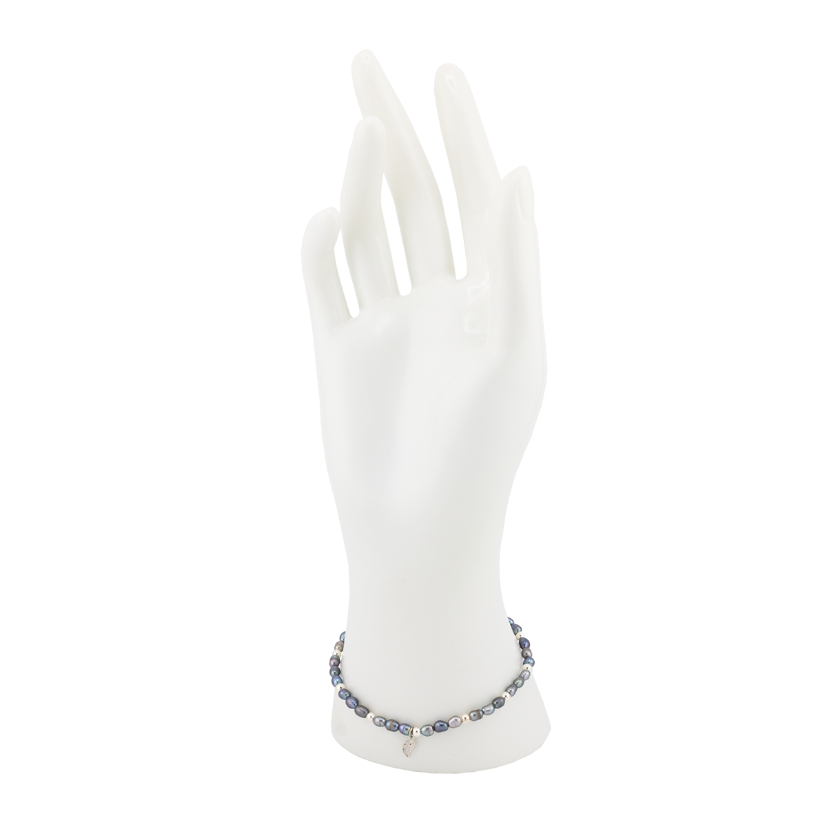 White gloves on a mannequin hand with a bracelet on a white background