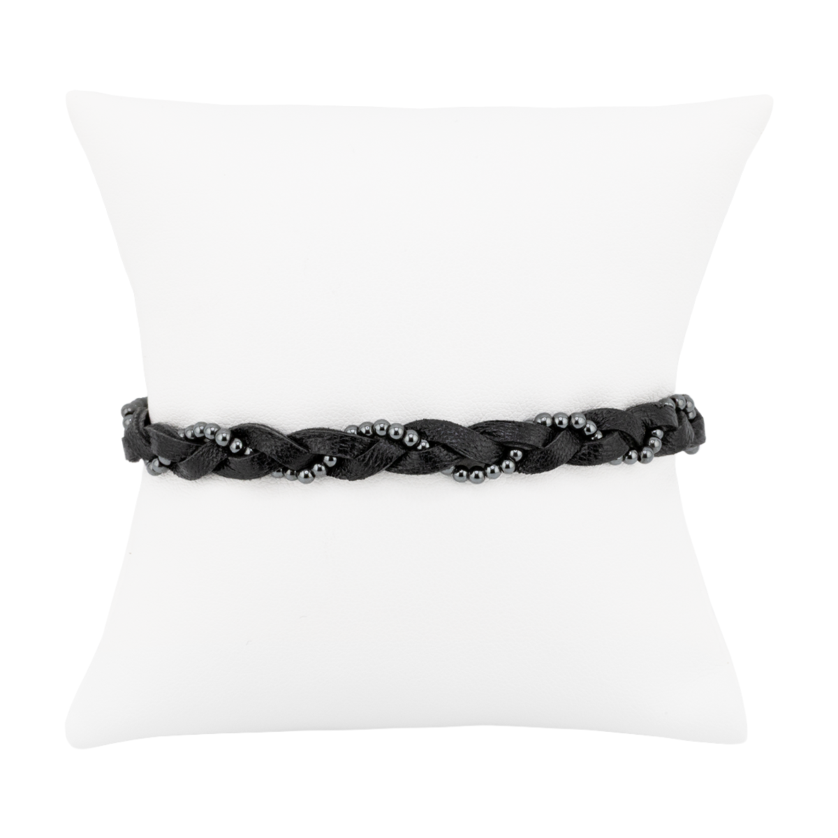 Black braided bracelet on a white pillow