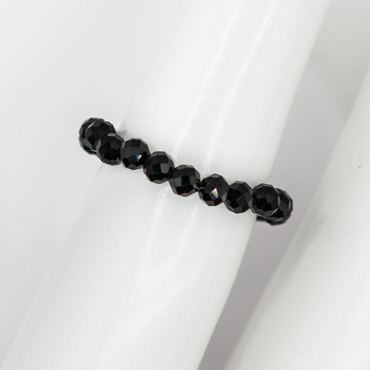 Black beaded bracelet on a white background