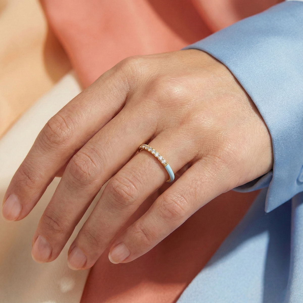 Close-up of a hand wearing a ring with a blurred background