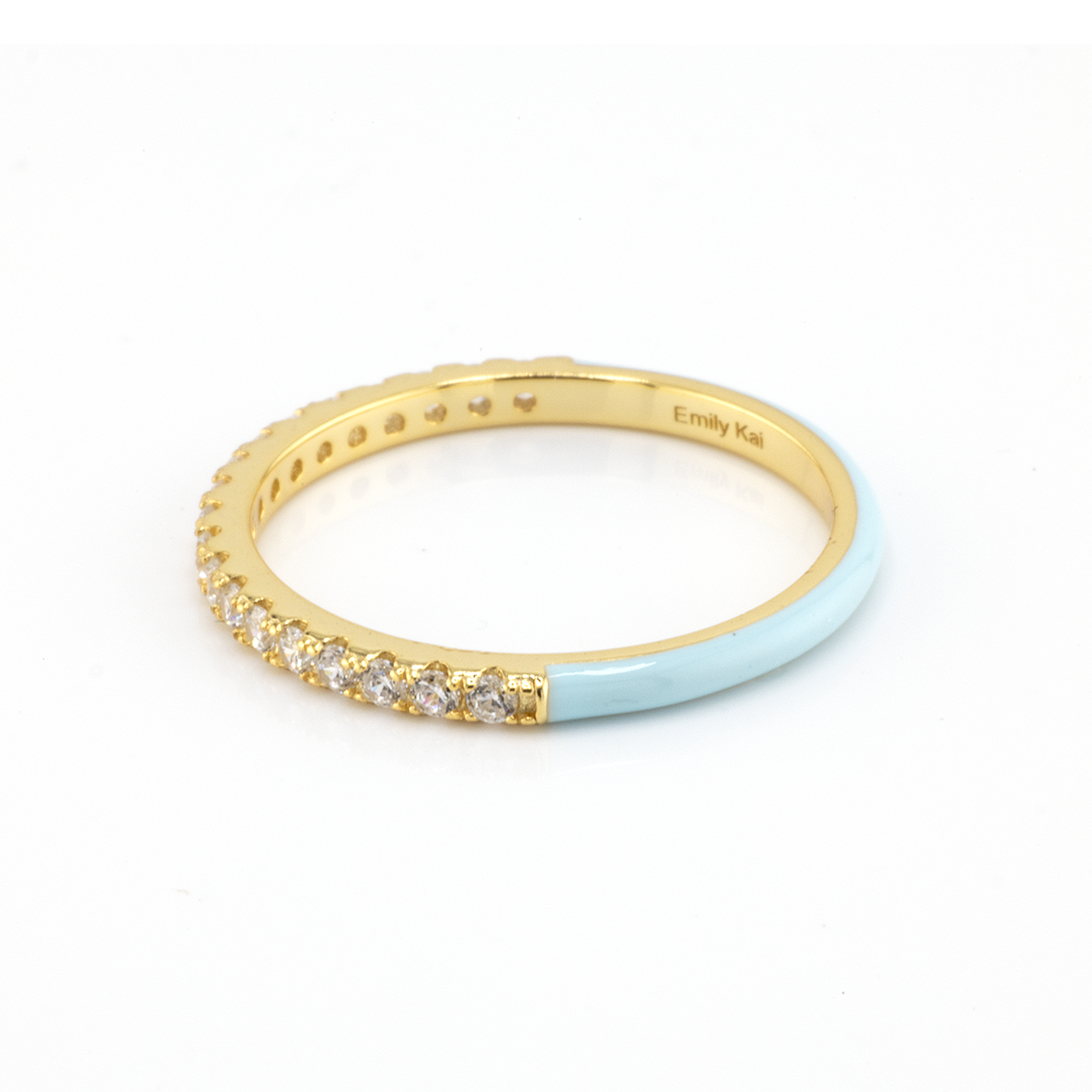 Gold ring with light blue band on a white background