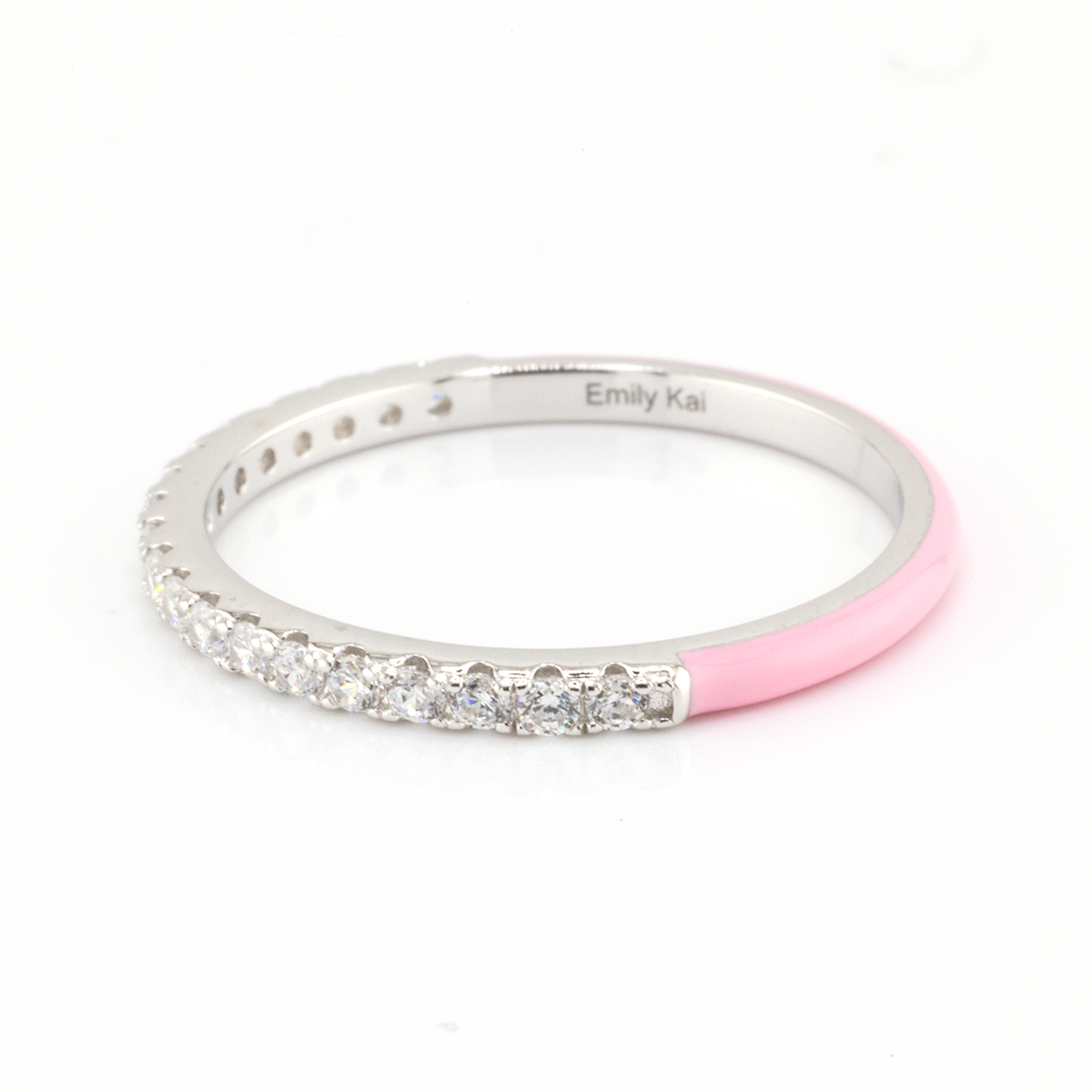 Silver ring with pink accent and clear stones on a white background