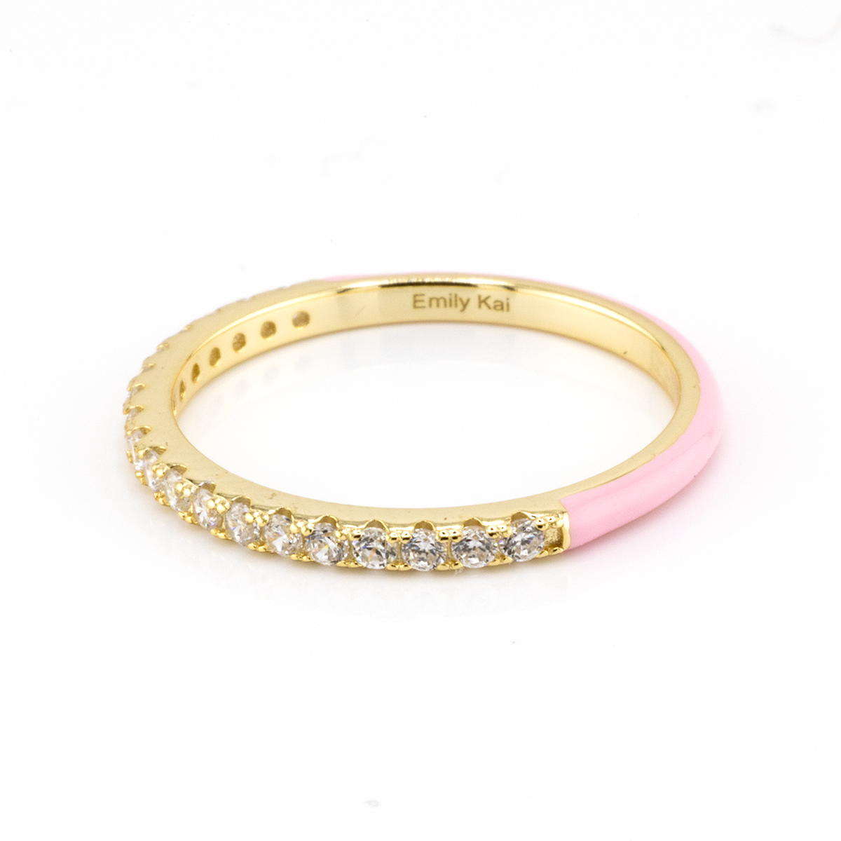 Gold ring with pink section and embedded diamonds on a white background
