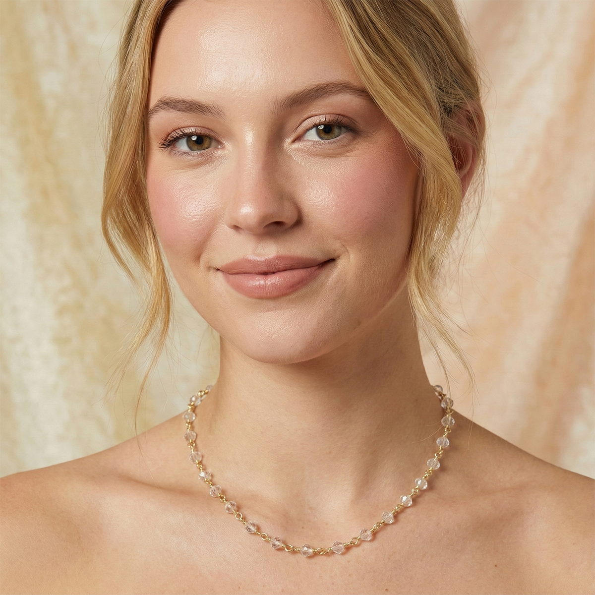 Woman wearing a pearl necklace against a soft beige background