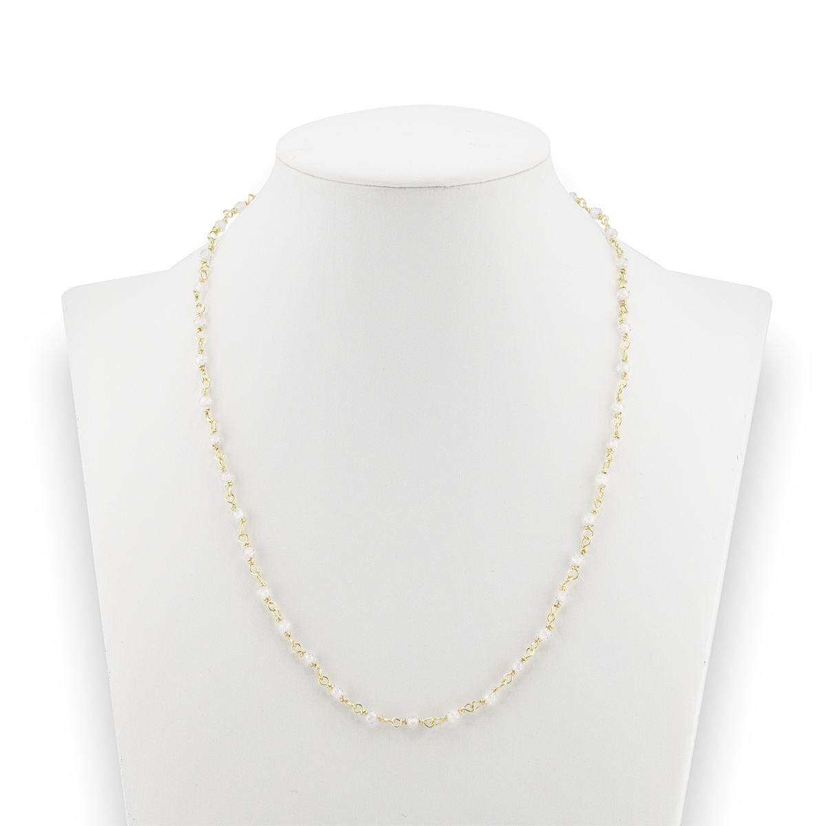 Gold necklace on a mannequin with a white background