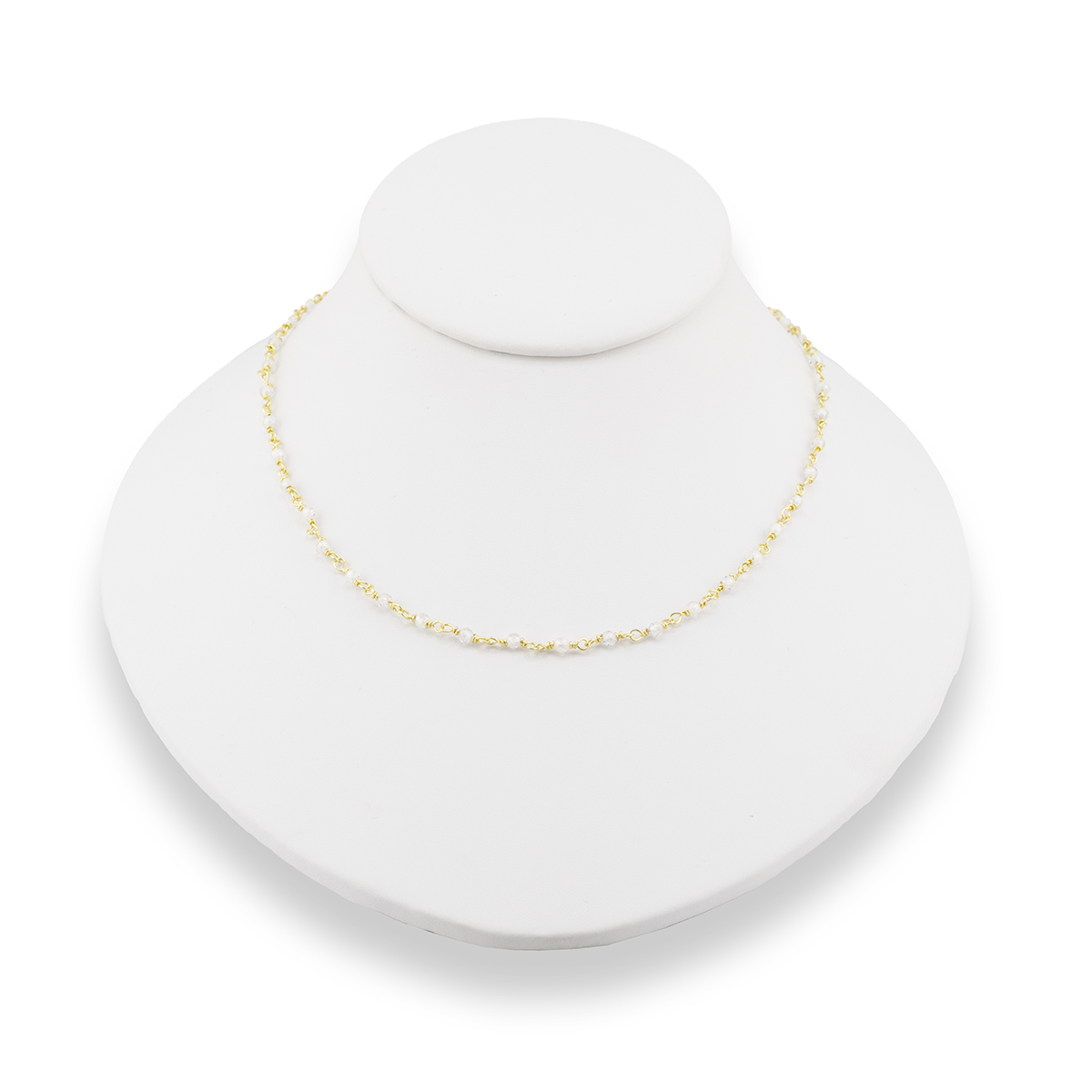 Gold necklace on a white bust