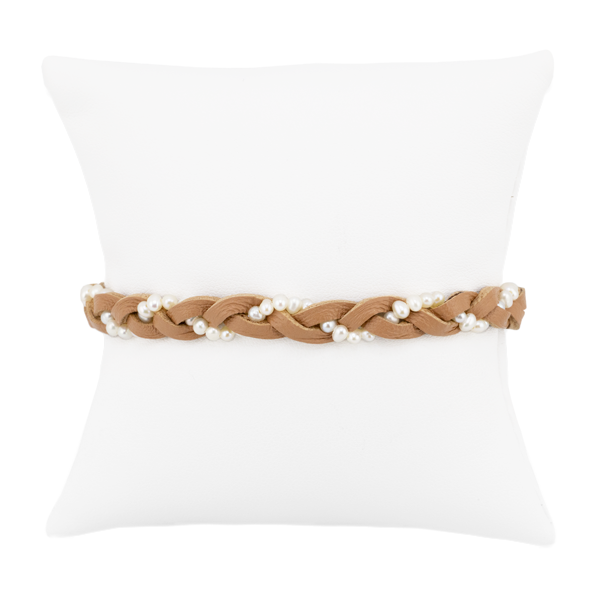 Braided belt with pearls on a white pillow