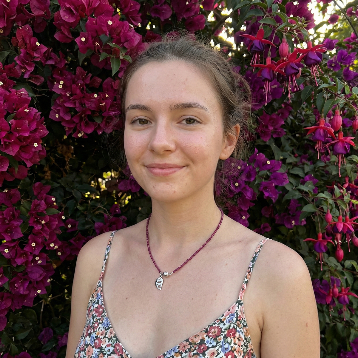 Woman standing in front of purple flowers