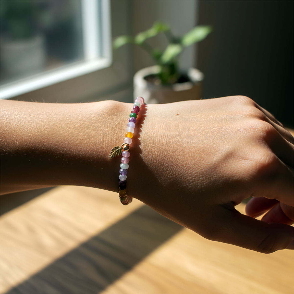 Close-up of a wrist wearing a colorful beaded bracelet with a soft focus background