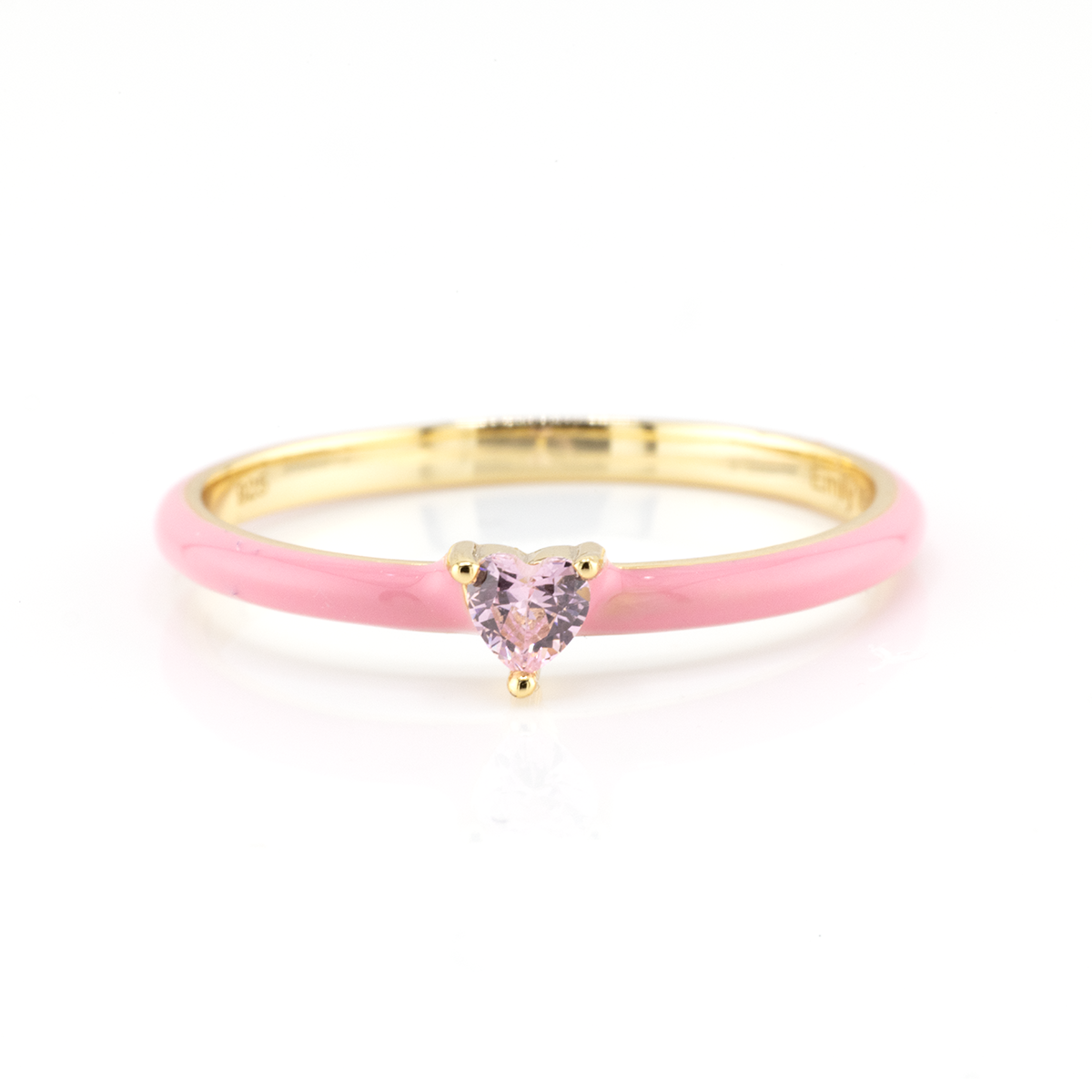Gold ring with a pink heart-shaped gemstone on a white background