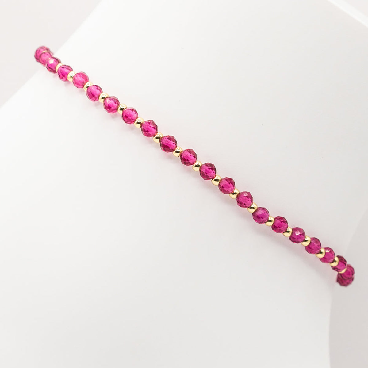 Bracelet with pink beads on a white background