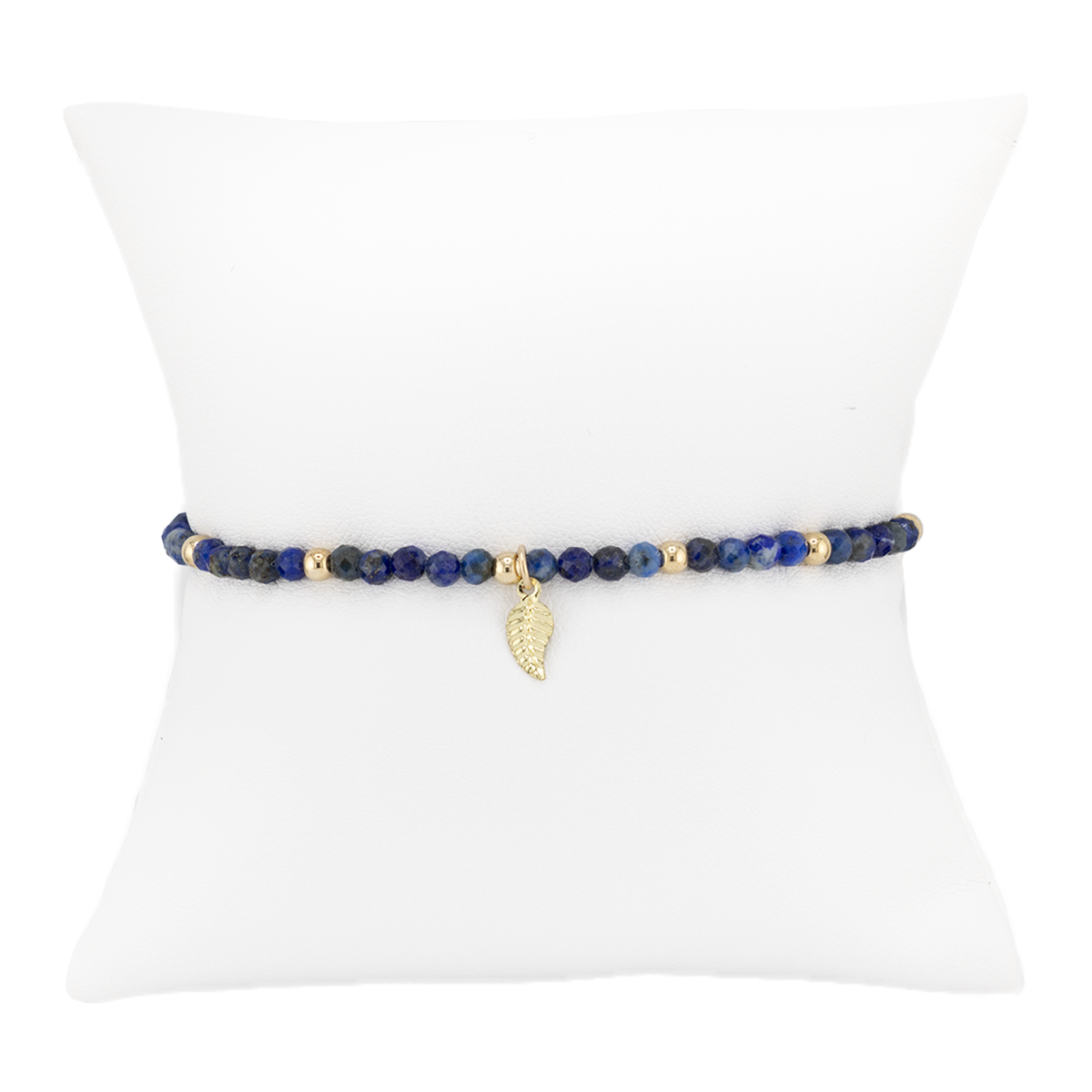 Navy beaded bracelet with a gold leaf charm on a white background