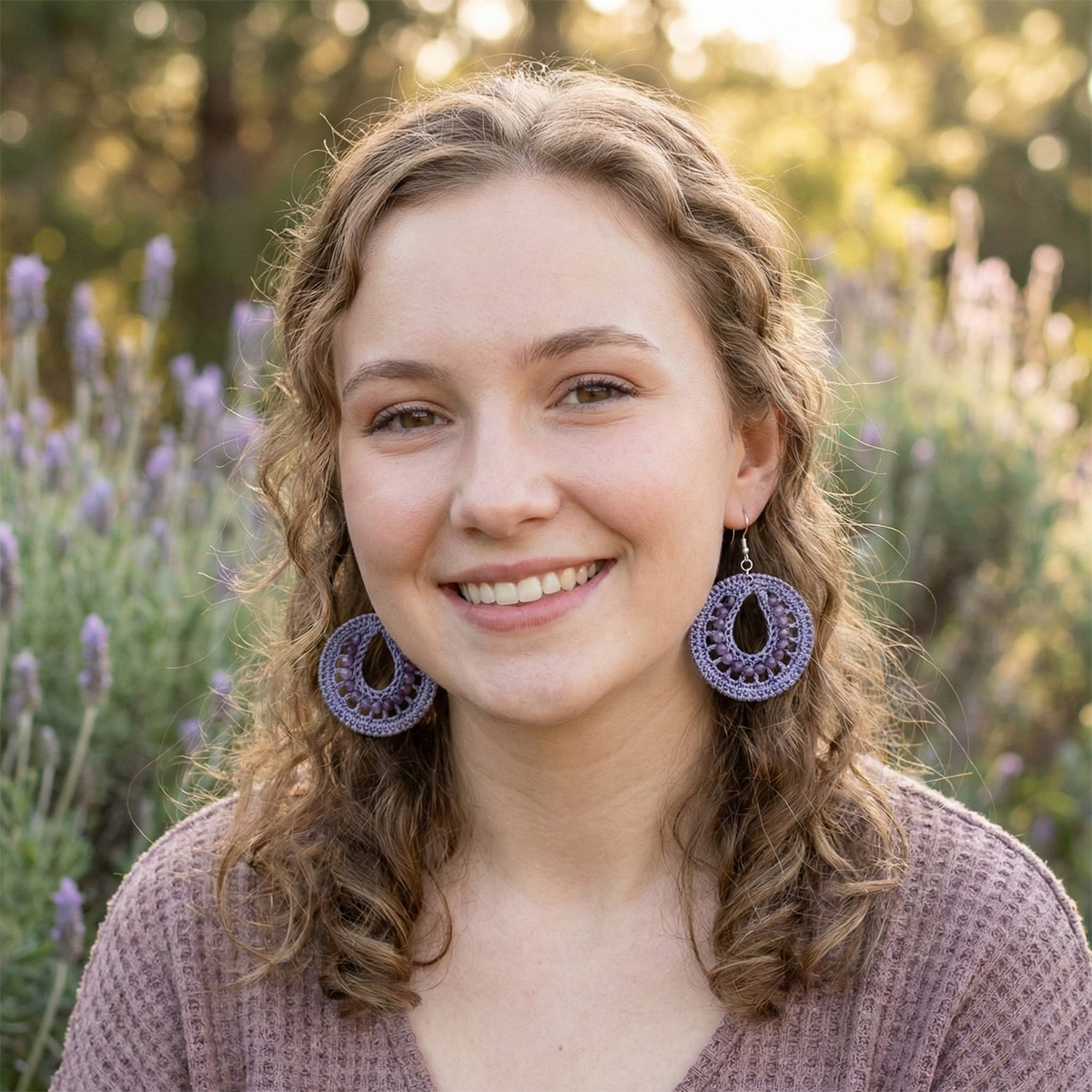 Woman wearing purple earrings in a lavender field