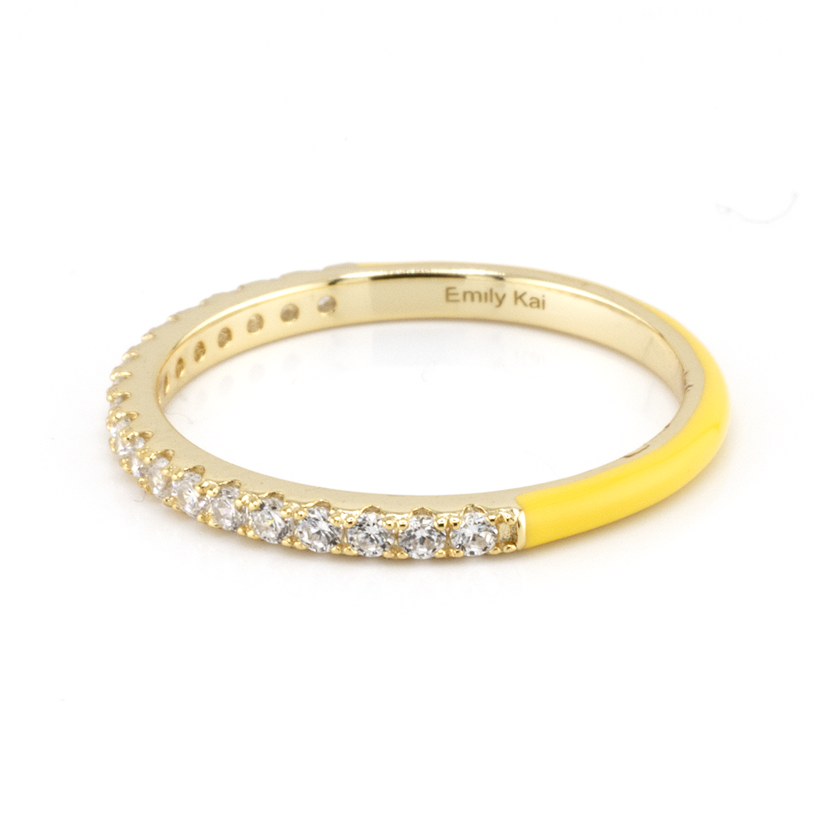 Gold ring with yellow accent and diamond stones on a white background