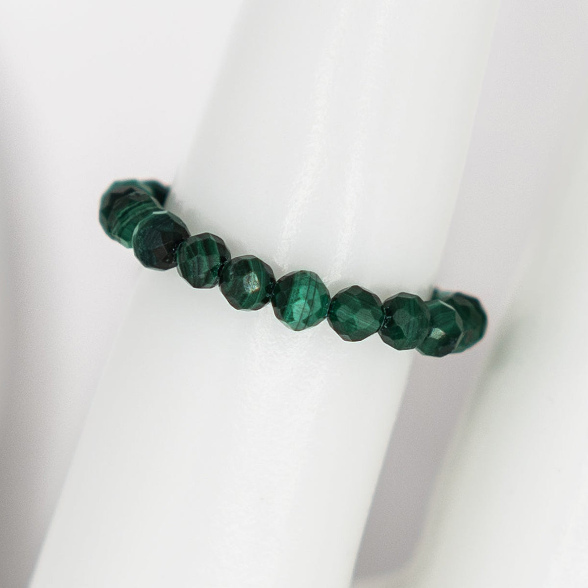 Green beaded bracelet on a white background