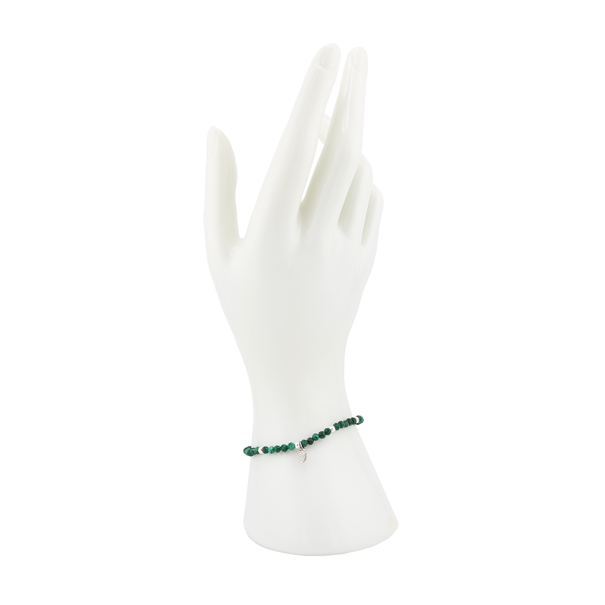 Green beaded bracelet on a white mannequin hand against a white background