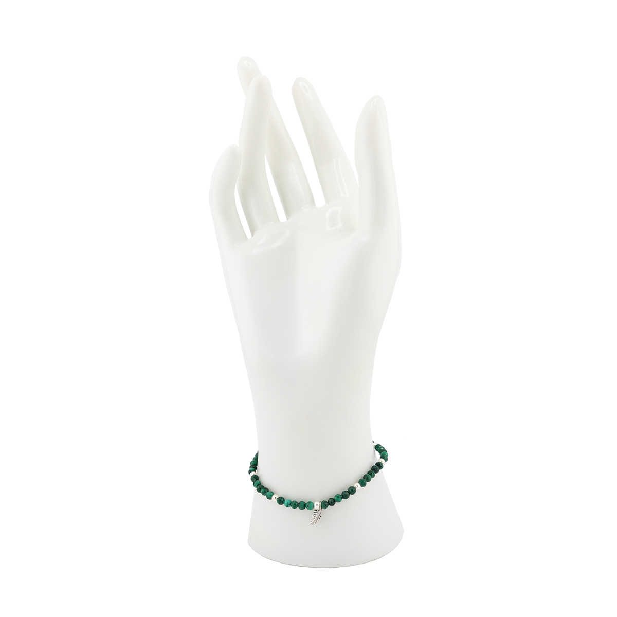 Green beaded bracelet on a white mannequin hand against a white background