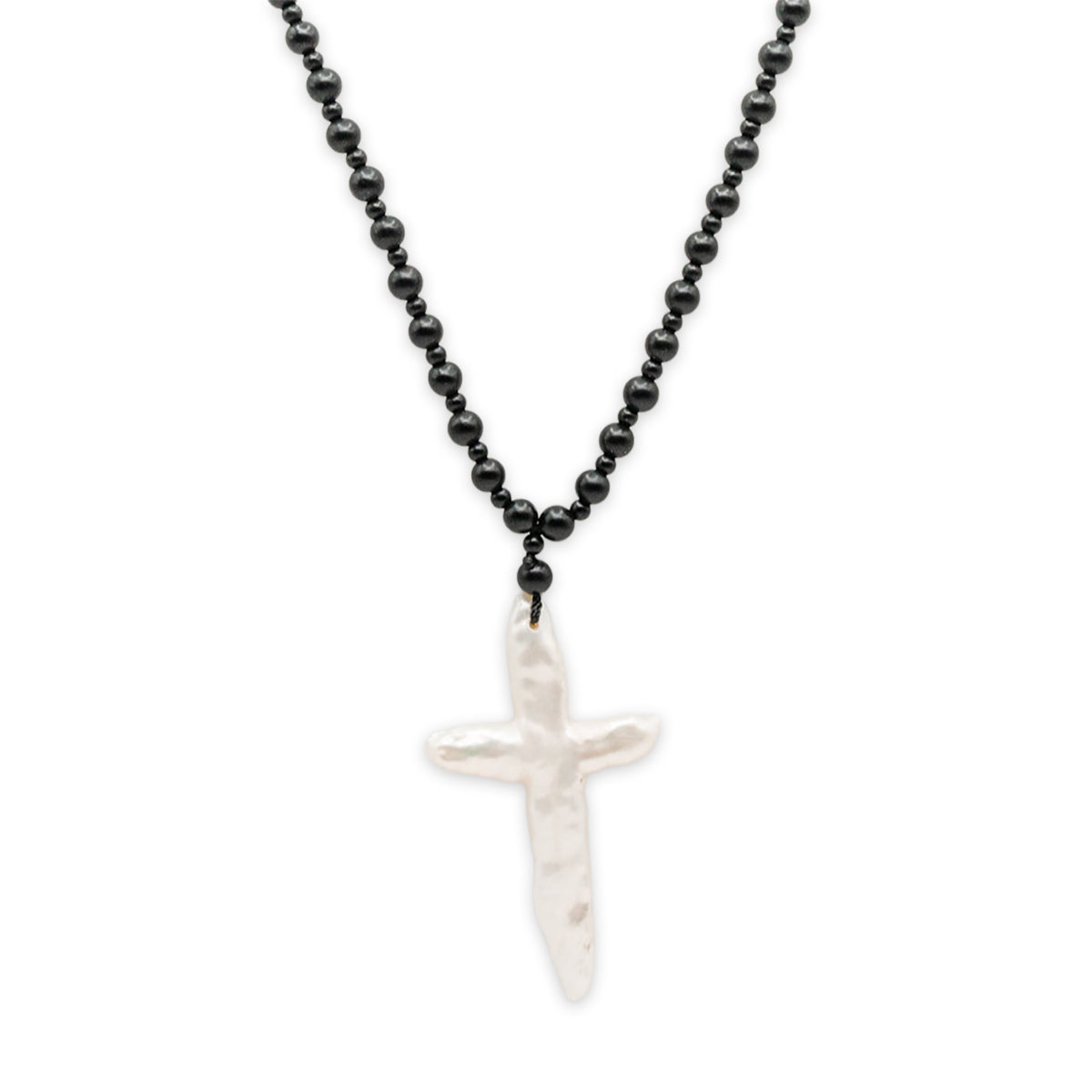 Necklace with black beaded chain and white cross pendant on a white background