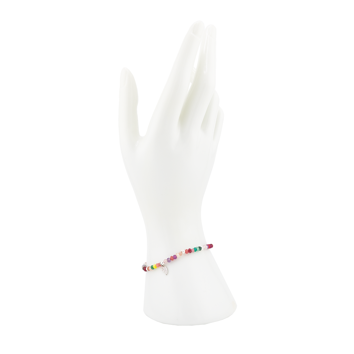 Multicolored beaded bracelet on a white mannequin foot against a white background