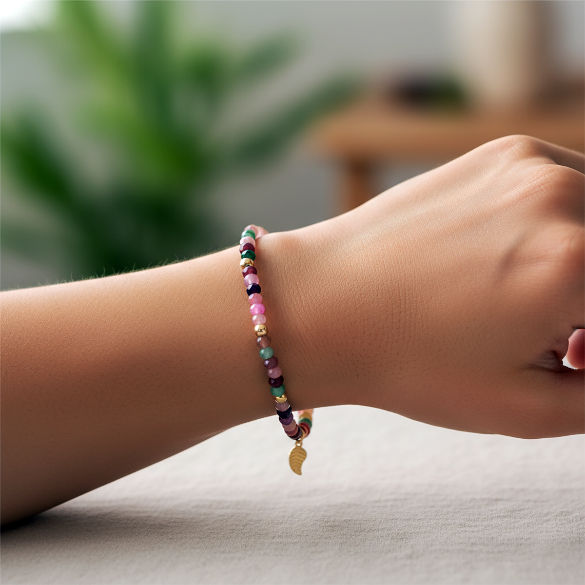 Multicolored beaded bracelet on a wrist with a blurred indoor background