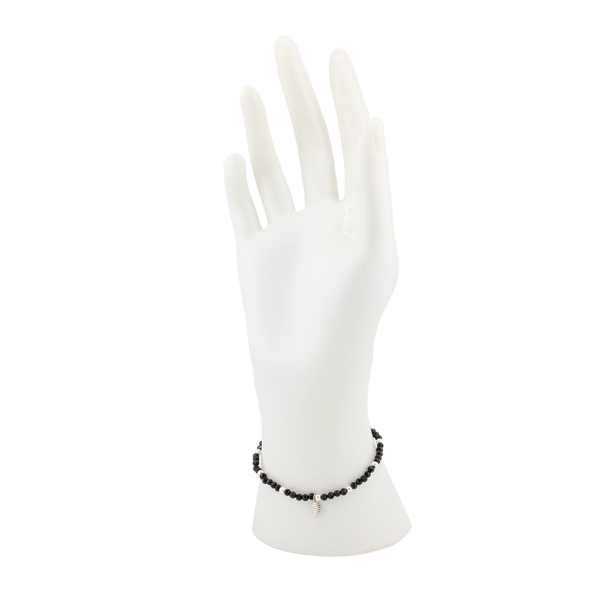White gloves on a mannequin hand with a black beaded bracelet.