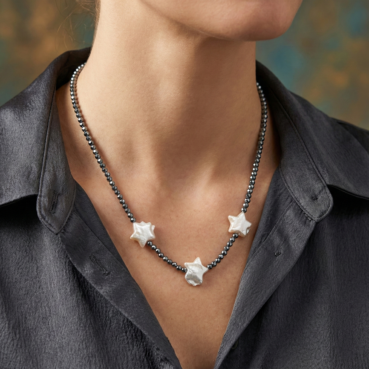 Star-shaped necklace worn by a person with a blurred background