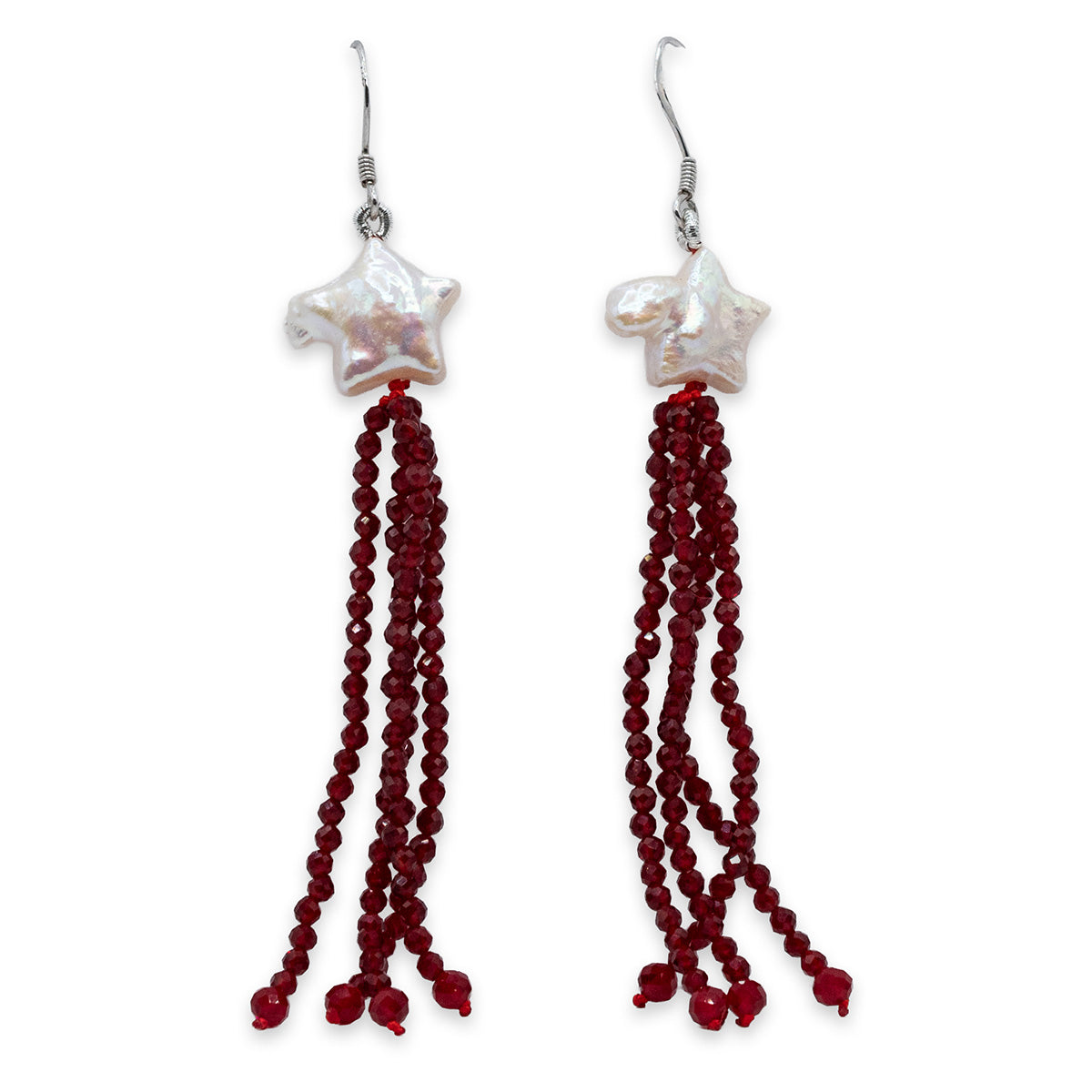 Pair of earrings with star-shaped beads and red tassels on a white background