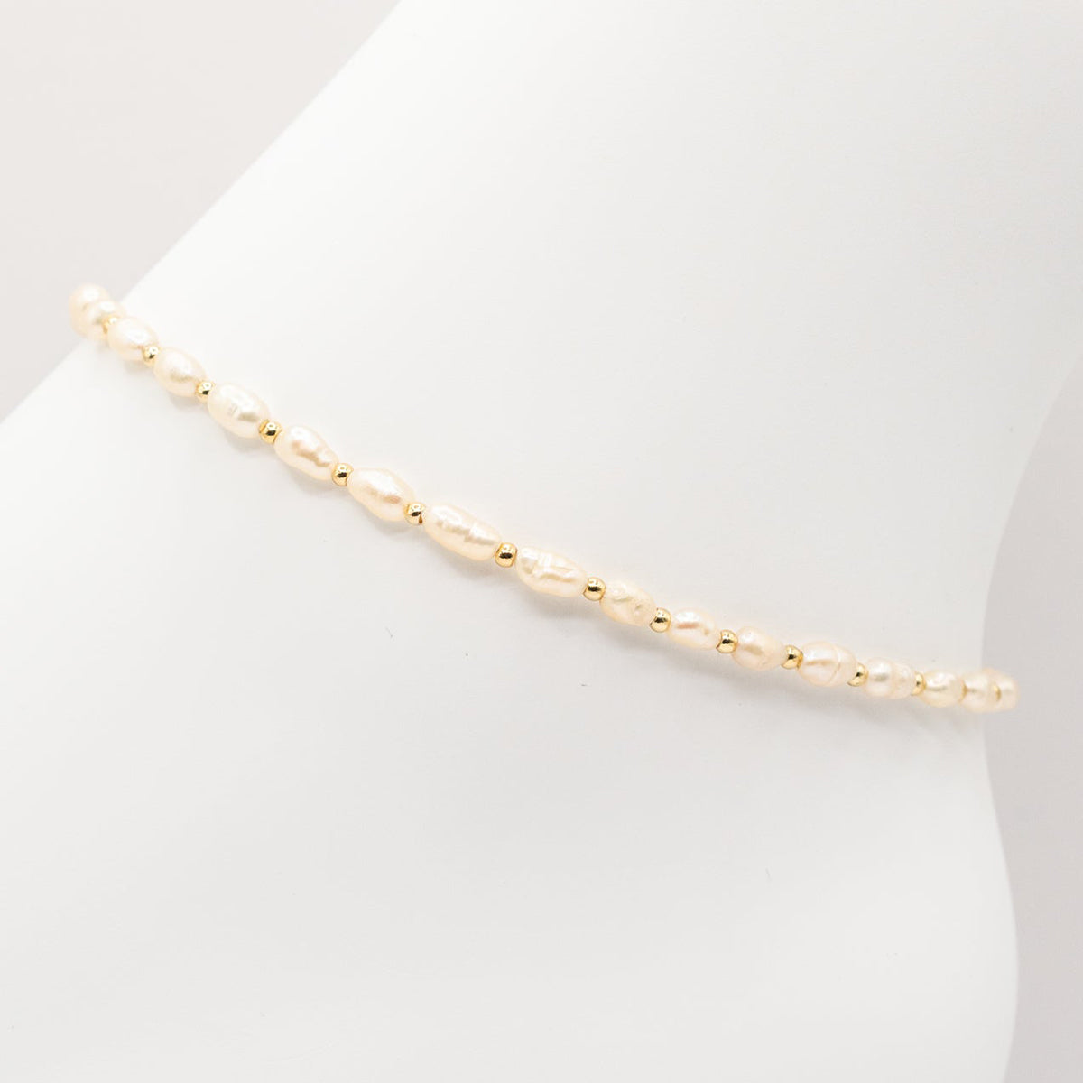 Gold bracelet on a white background