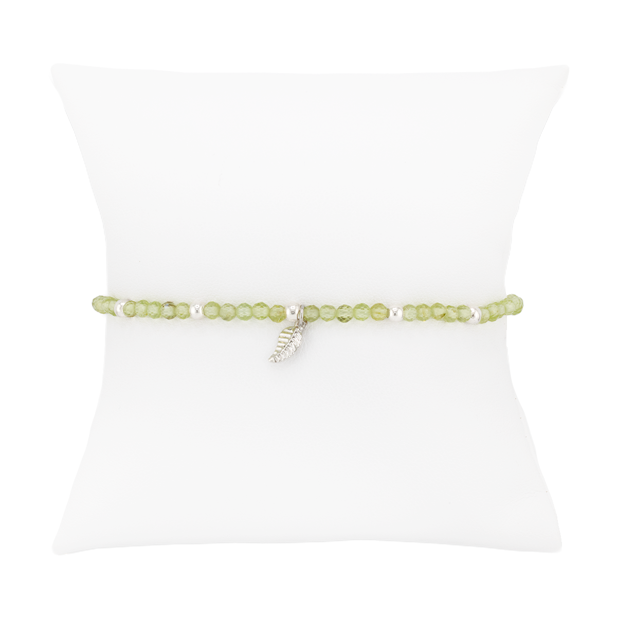 Green beaded bracelet with a silver charm on a white background
