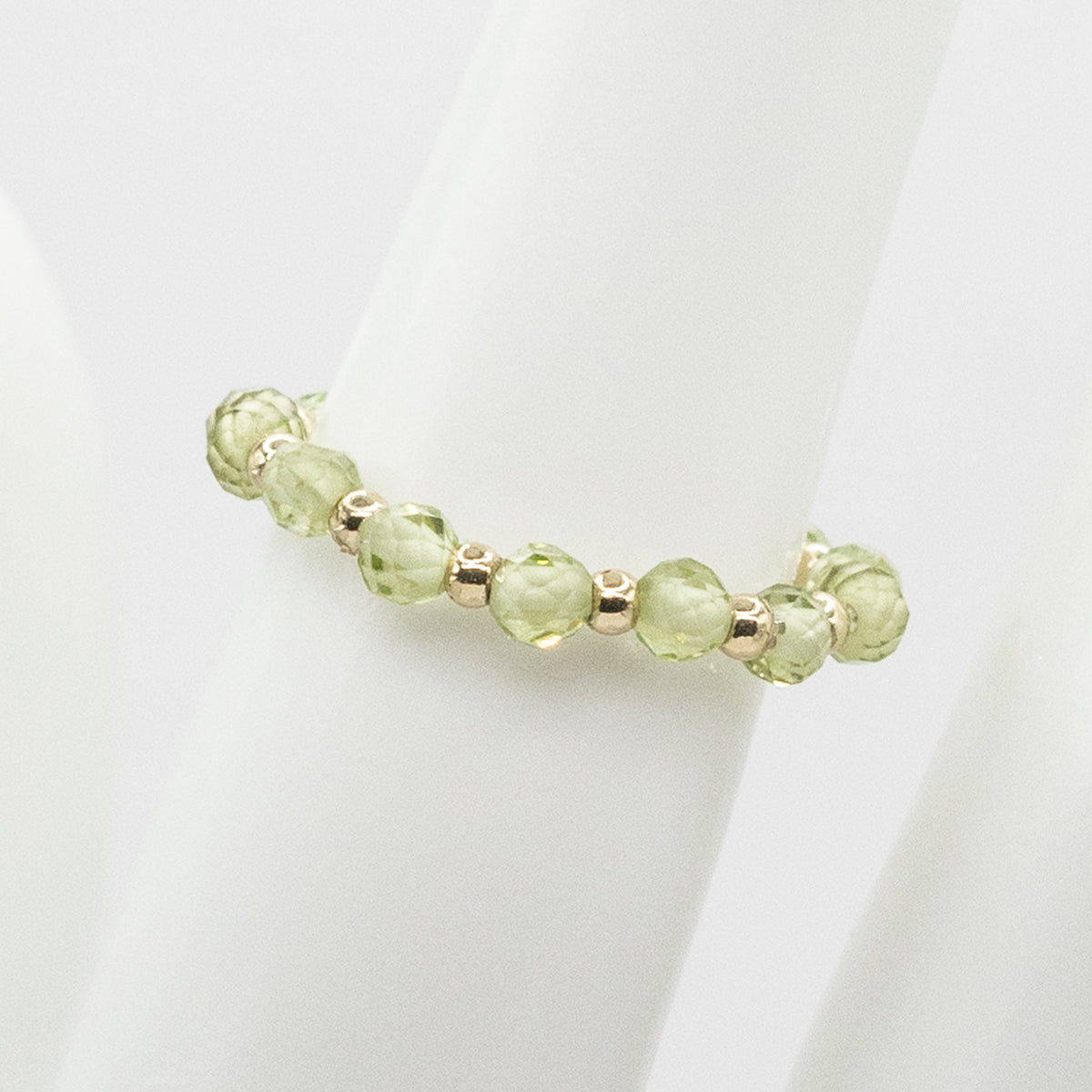 Green beaded bracelet on a white background