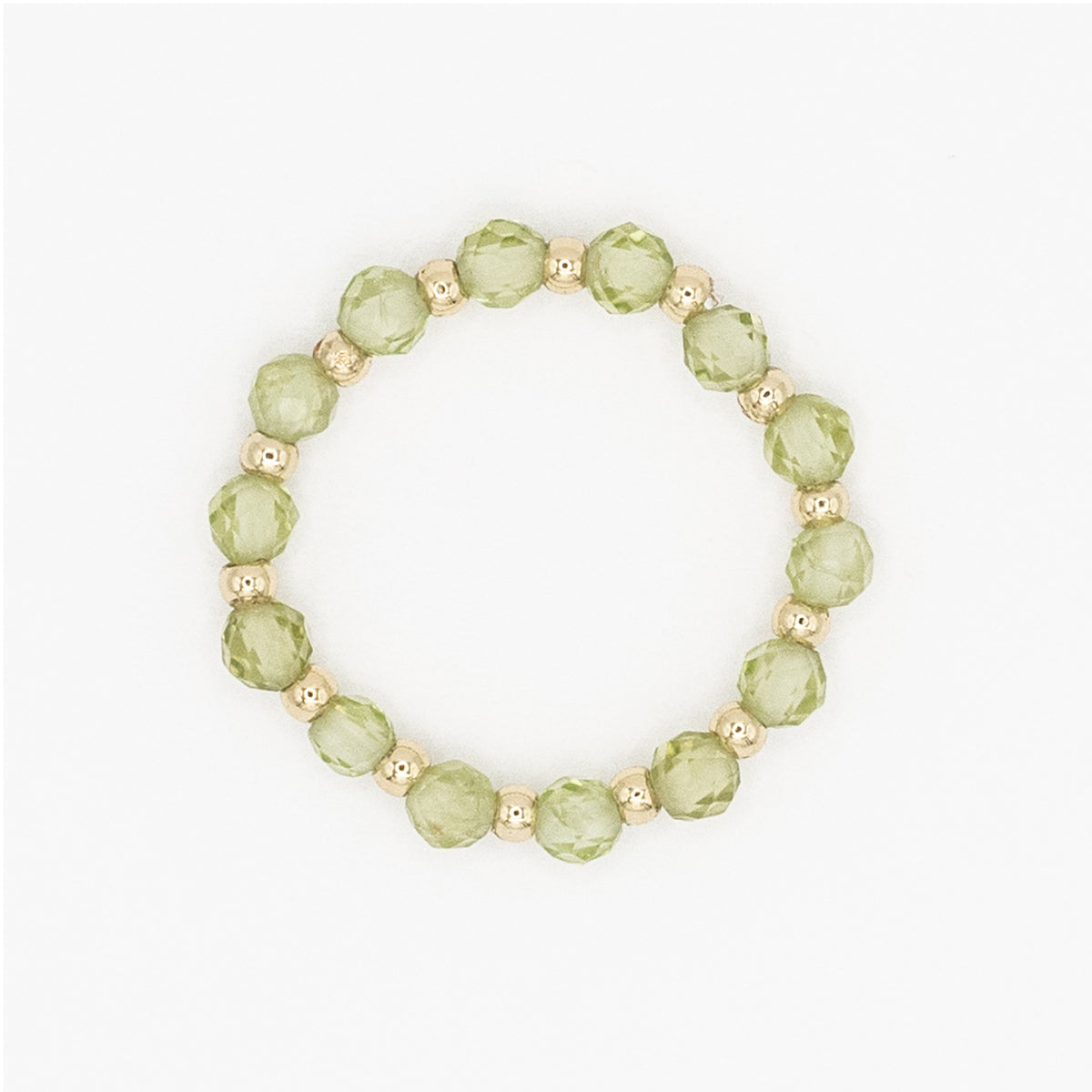 Green beaded ring with gold accents on a white background