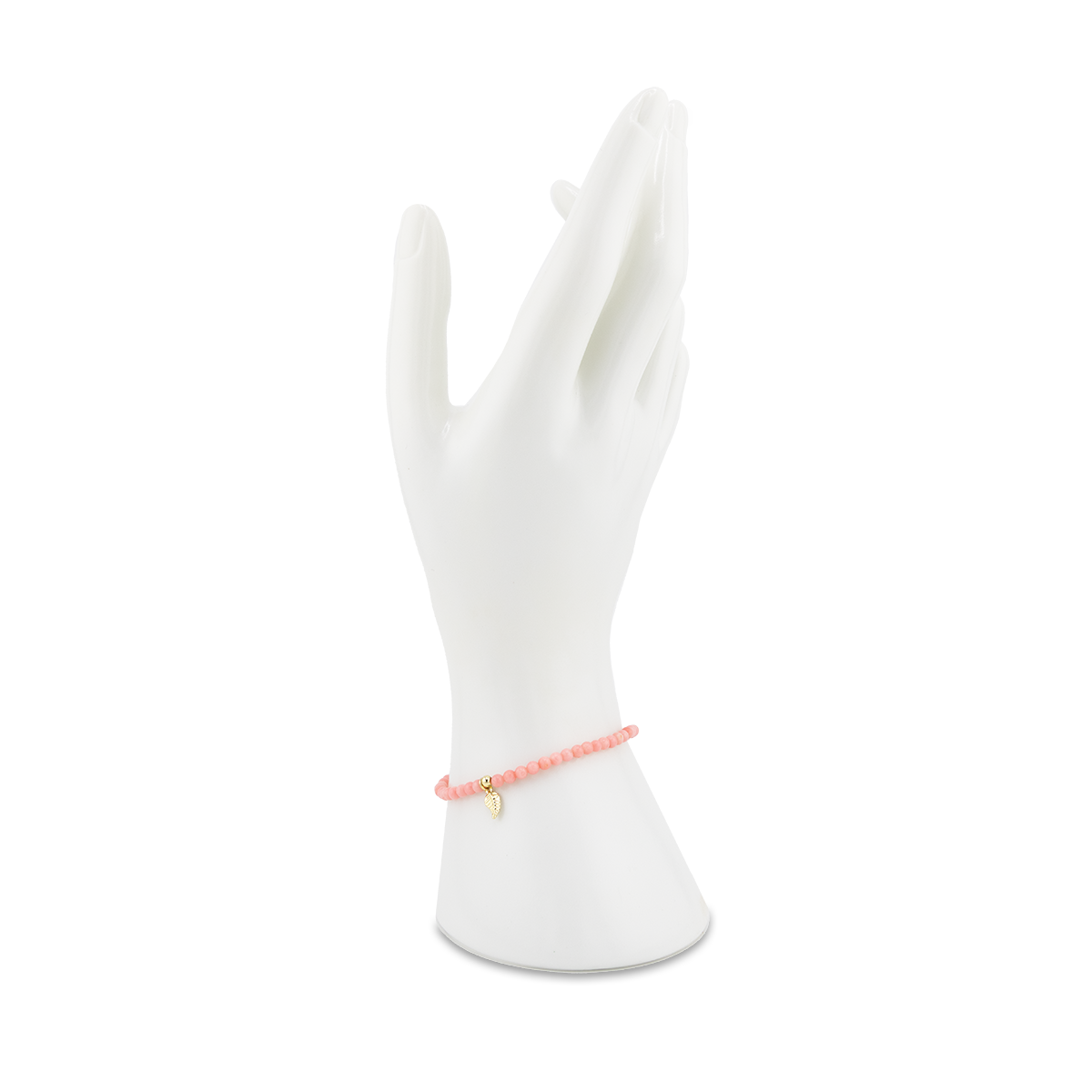Pink bracelet on a white mannequin hand against a white background