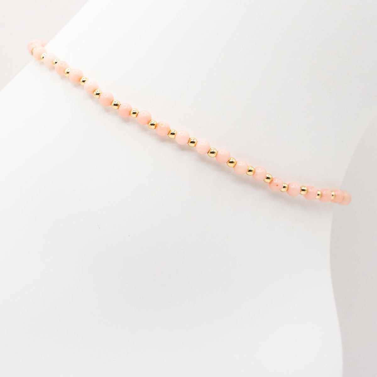 Necklace with pink beads on a white background