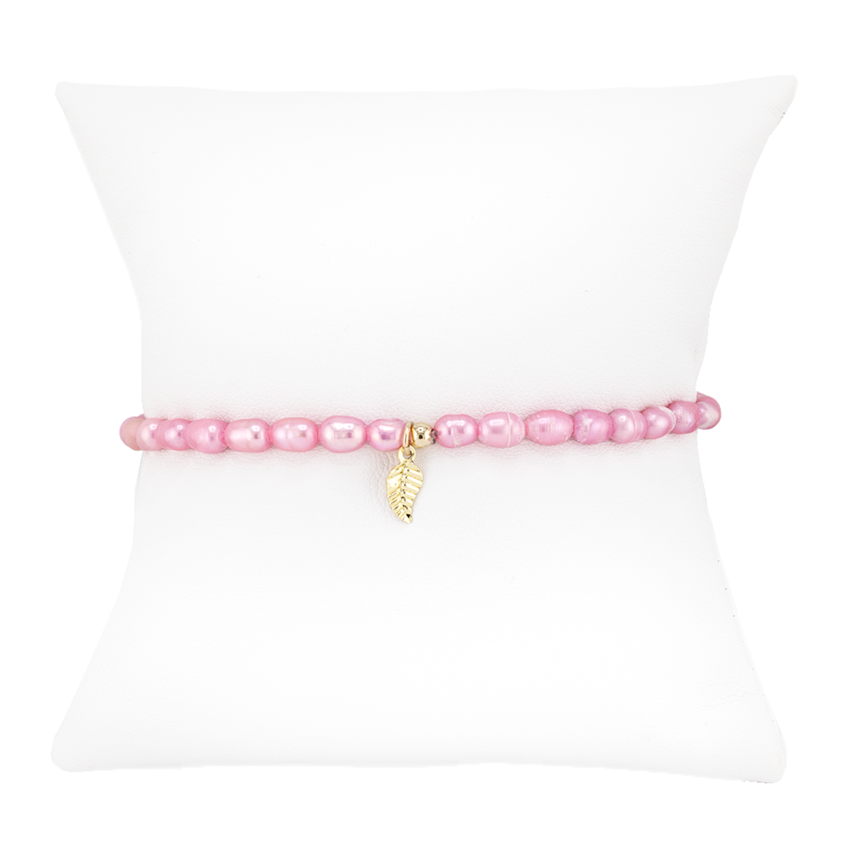 Pink pearl bracelet with a gold charm on a white background