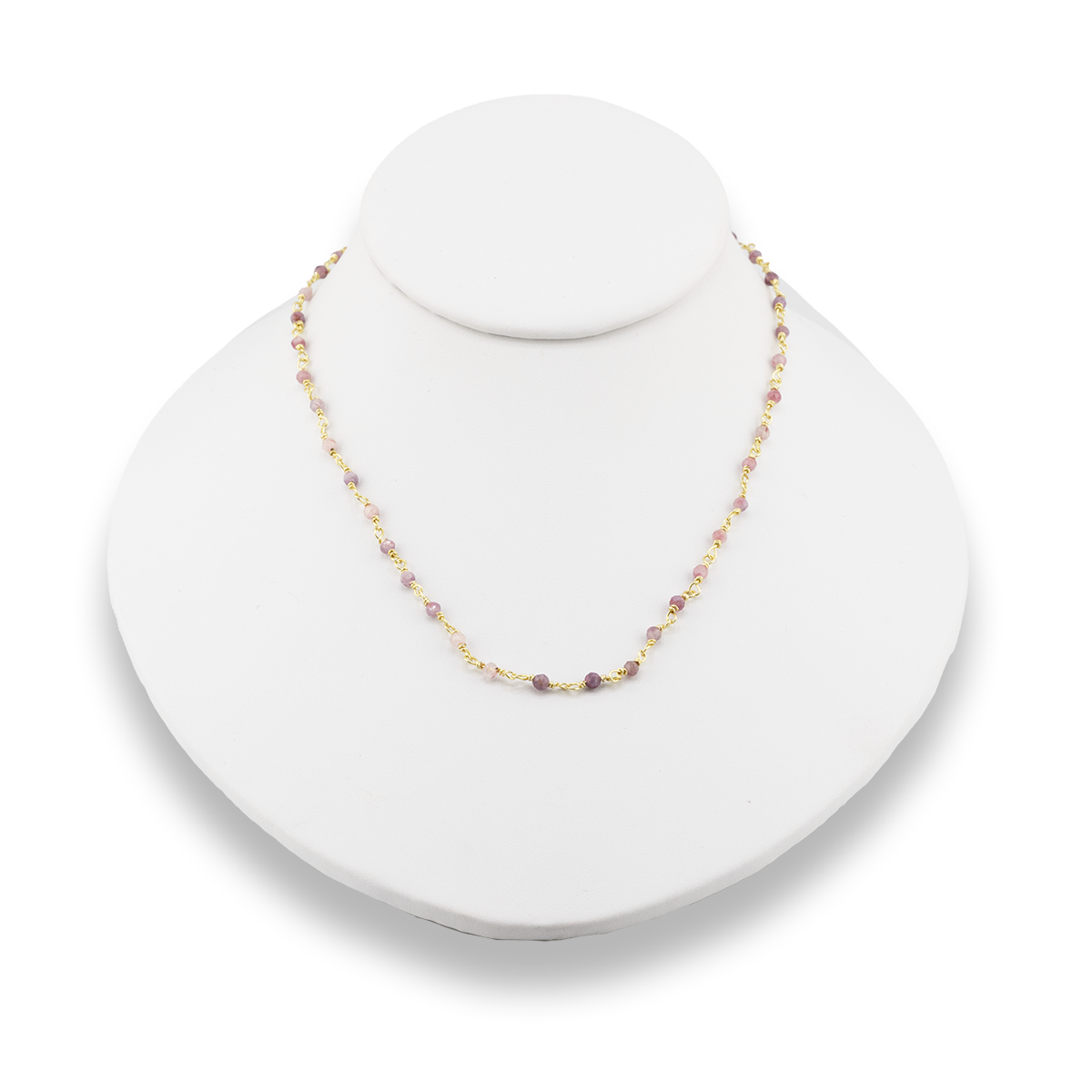 Necklace with small beads on a white stand