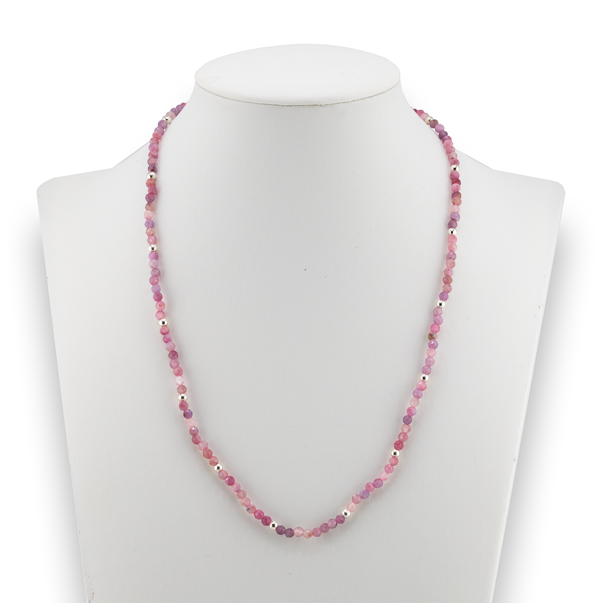 Necklace with pink beads on a mannequin against a white background