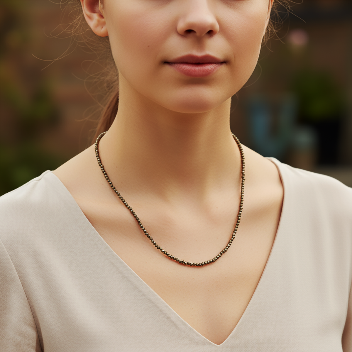 Woman wearing a necklace with a blurred background