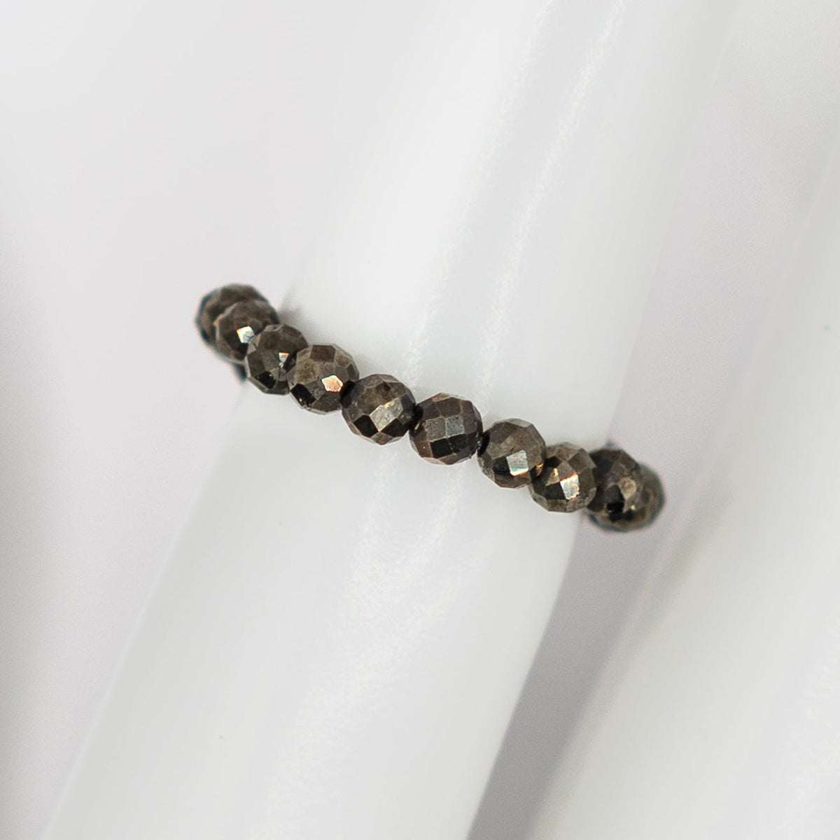 Bracelet with dark beads on a white background