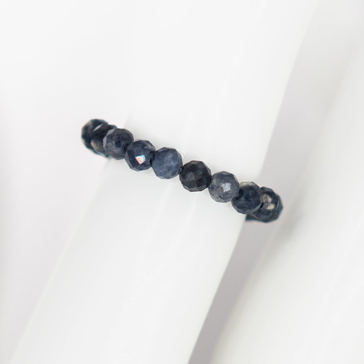 Necklace with dark blue beads on a white background