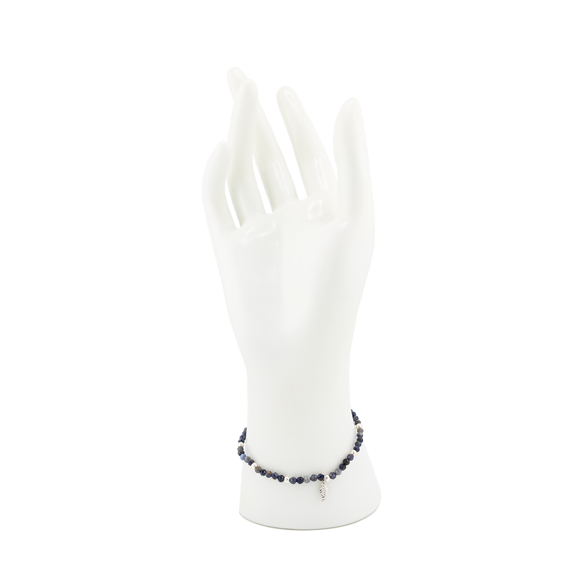 White mannequin arm with a bracelet on a white background