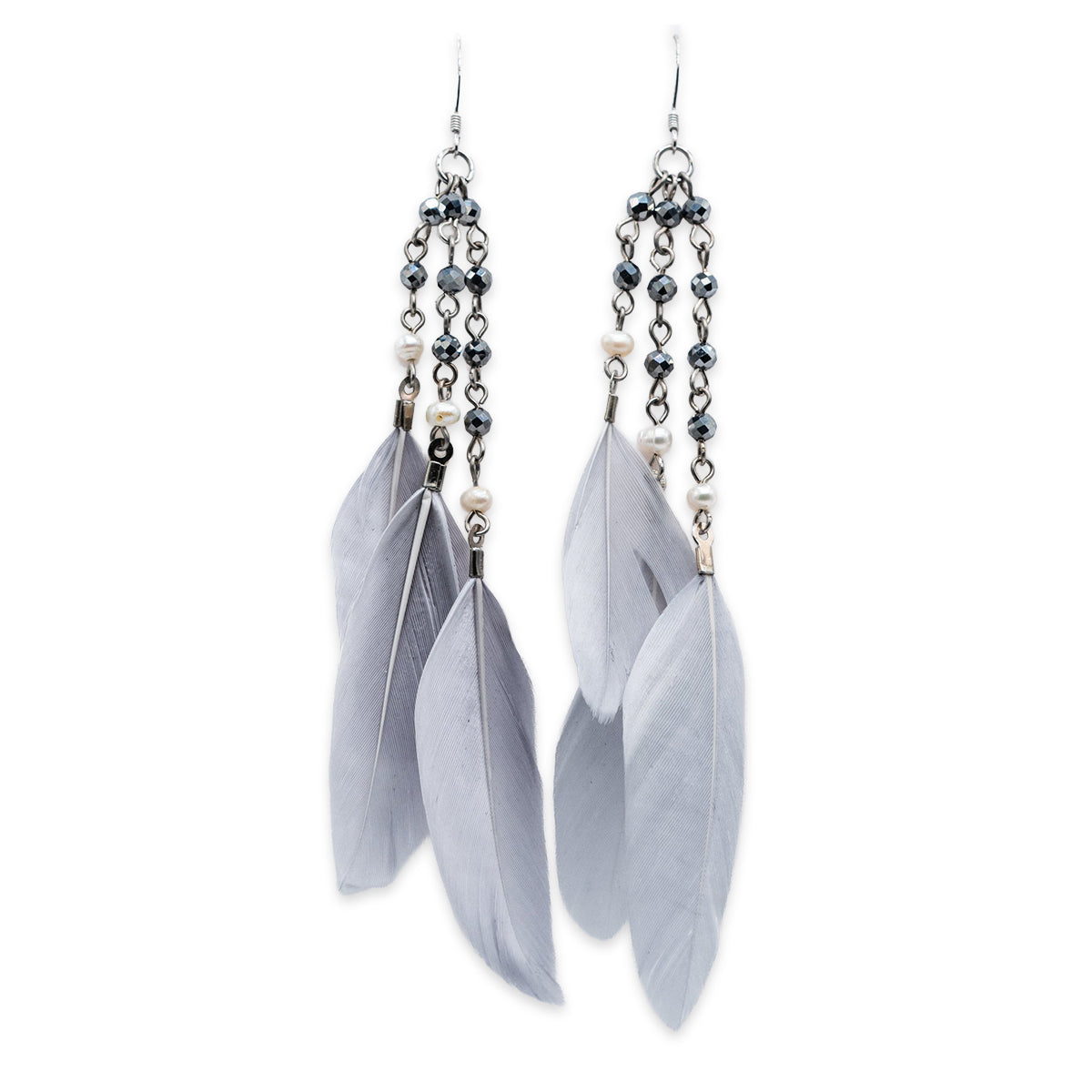 Feather and beaded earrings on a white background