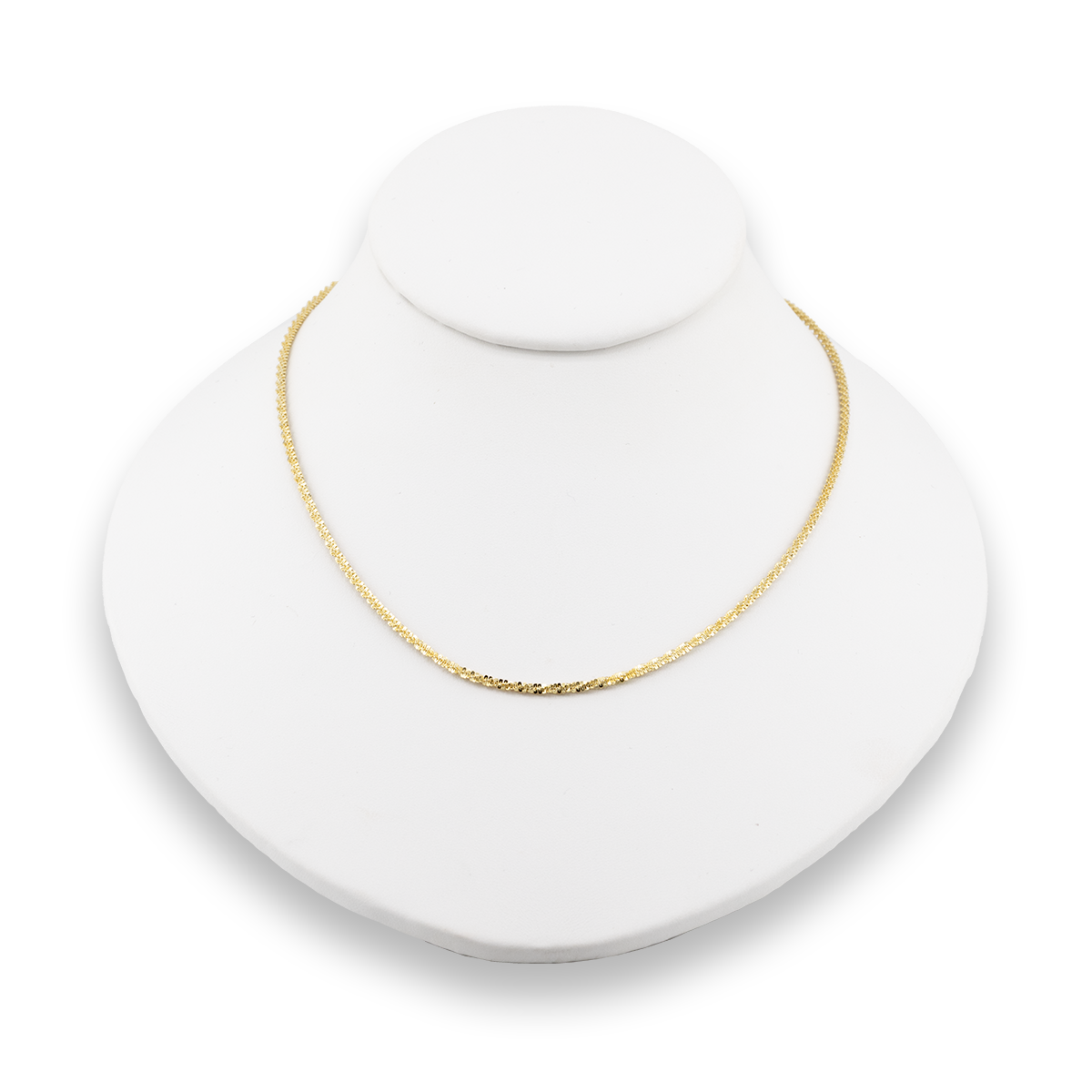 Gold necklace on a white jewelry display