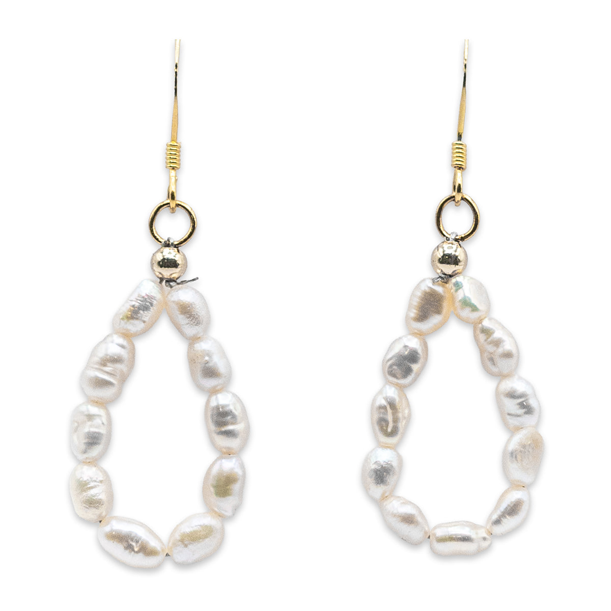 Pair of pearl earrings with gold hooks on a white background