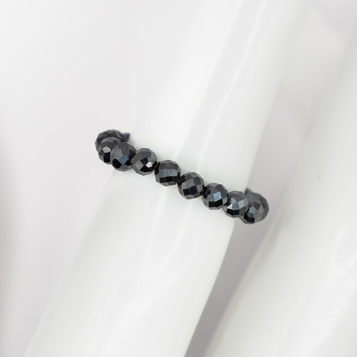 Black beaded bracelet on a white background