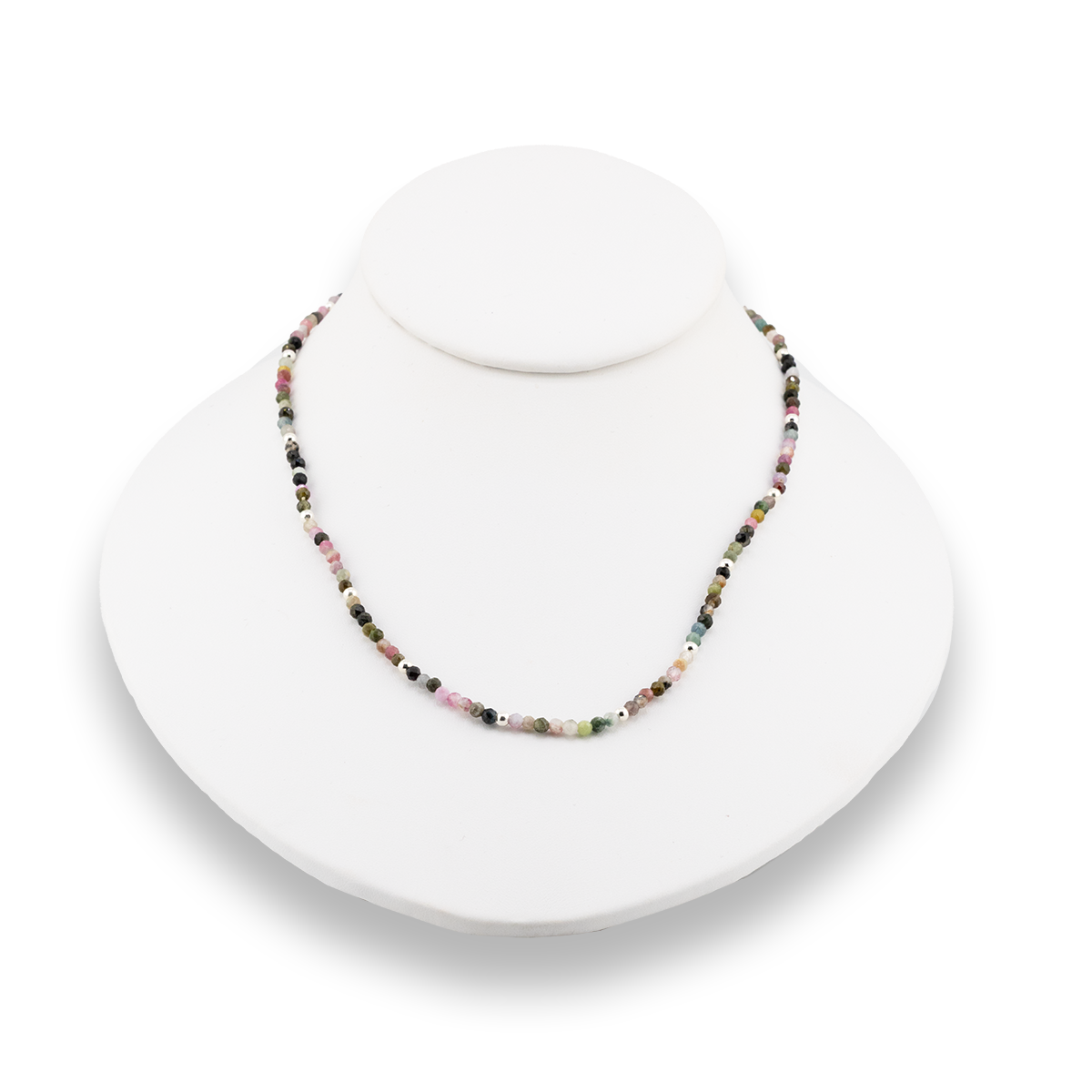 Necklace with multicolored beads on a white stand against a white background